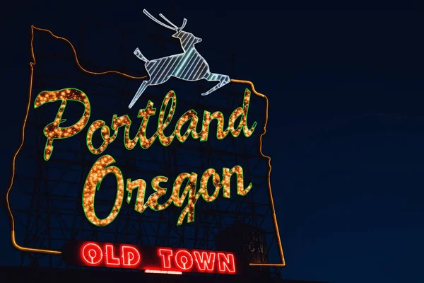 Iconic Portland, Oregon Old Town sign with an outline of Oregon and a stag at night