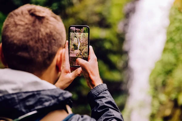 Man Taking Picture Scenic Waterfall His Phone Close View — Stock Fotó
