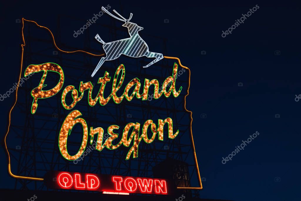 Iconic Portland, Oregon Old Town sign with an outline of Oregon and a stag at night