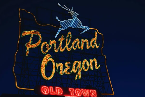 Iconic Portland, Oregon Old Town sign with an outline of Oregon and a stag at night