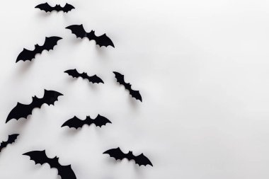 Bat silhouettes on the white wall with copy space. Minimalist Halloween decor