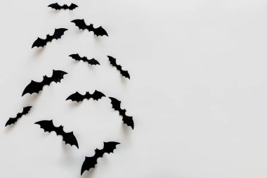 Bat silhouettes on the white wall with copy space. Minimalist Halloween decor