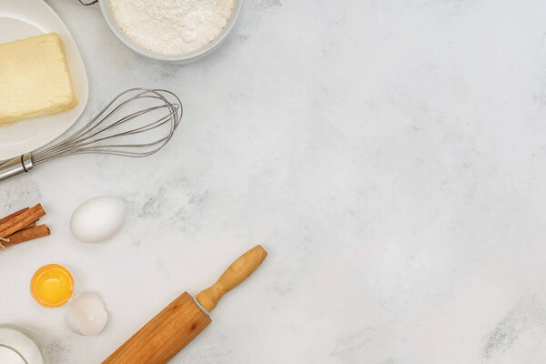 Ingredients and tools for baking, flat lay on marble table