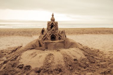Sand castle on the beach Barcelona. Spain clipart