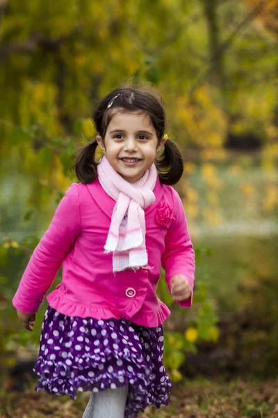Adorable girl in autumn park — Stock Photo, Image