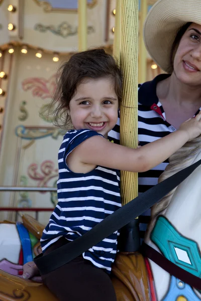 Mom and Daughter on merry-go-round — Stock Photo, Image