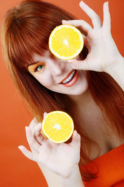 Redhead girl with orange — Stock Photo, Image