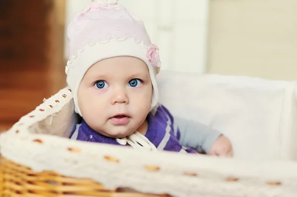 Sweet blue-eyes baby in basket — стоковое фото
