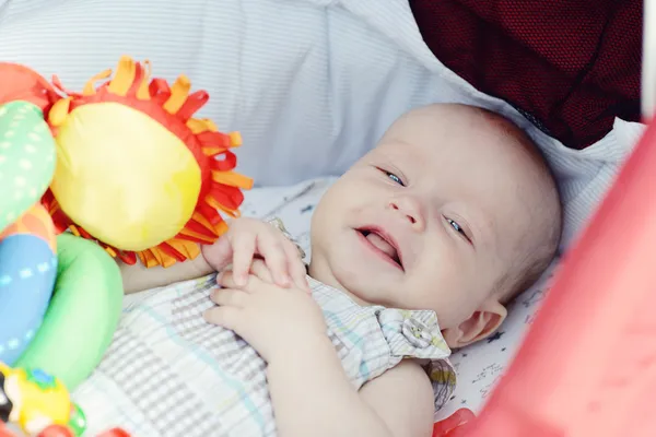 Baby boy laying in pram — Stock Photo, Image