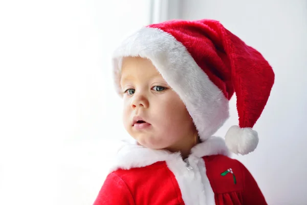 Baby santa looking in window Stock Photo