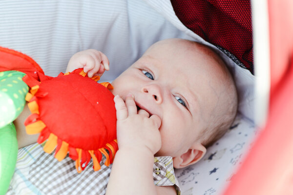 baby with fingers in mouth