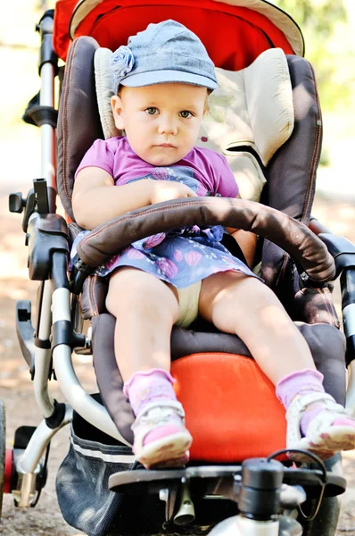 Cute baby girl in stroller — Stock Photo, Image