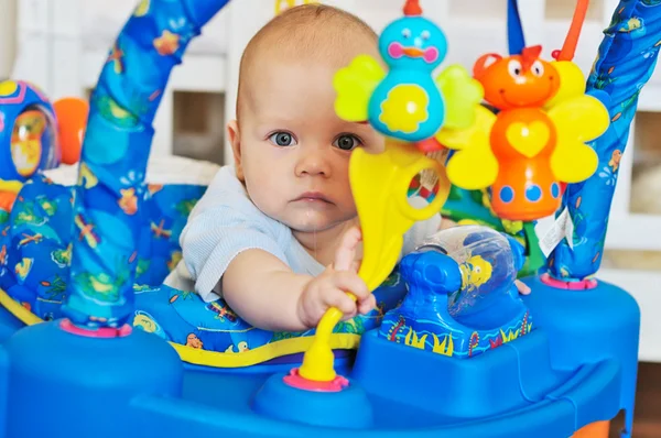 Funny baby in baby jumper — Stockfoto