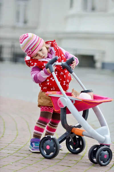 Girl with stroller — Stock Photo, Image