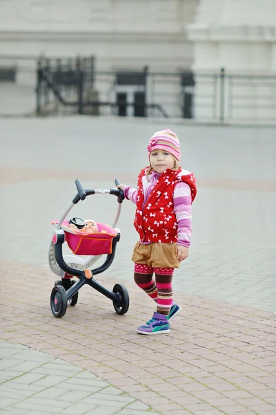 So cute toddler girl with toy stroller — Stock Photo, Image