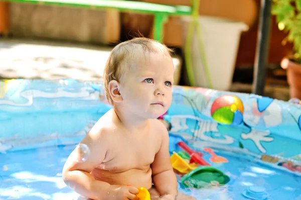 Baby girl sitting in the pool — Stock Photo, Image