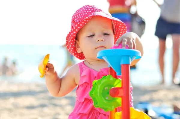 Baby playing toys on the beach — Stock Photo, Image