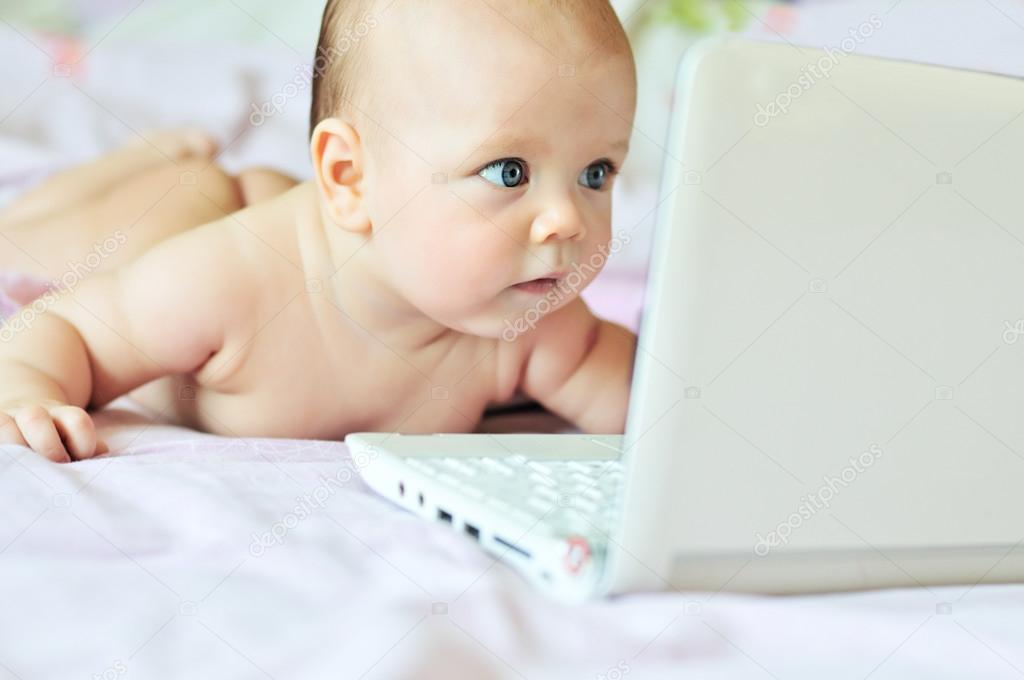  baby with laptop at home