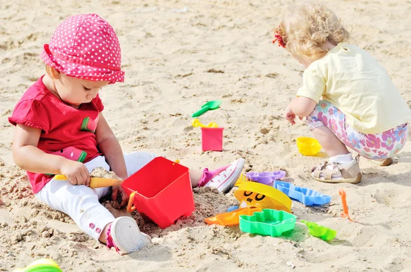 Babys spielen Spielzeug im Sand — Stockfoto