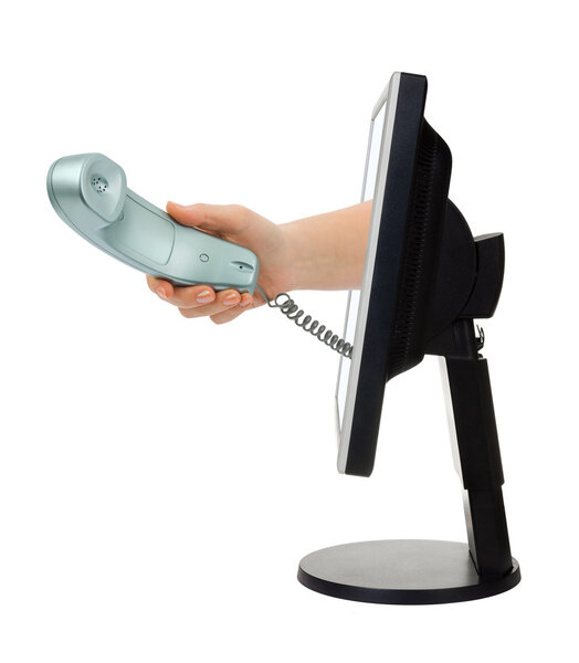 Computer screen and hand with phone