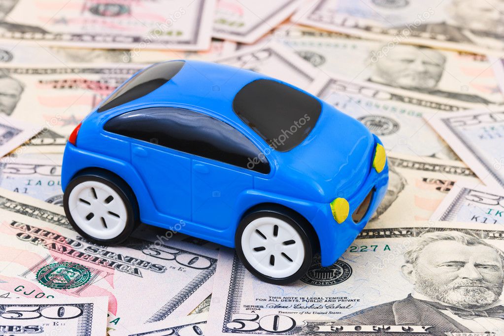 Toy car on money background