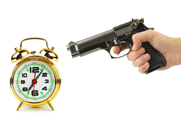 Hand with gun and alarm clock — Stock Photo, Image