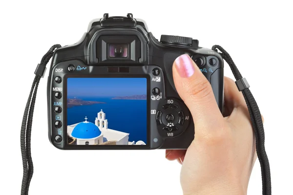 Camera in hand and Santorini (Greece) view — Stock Photo, Image