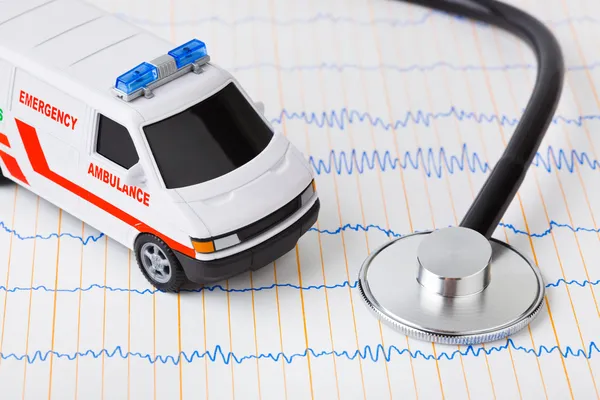 Stethoscope and ambulance car on ecg — Stock Photo, Image