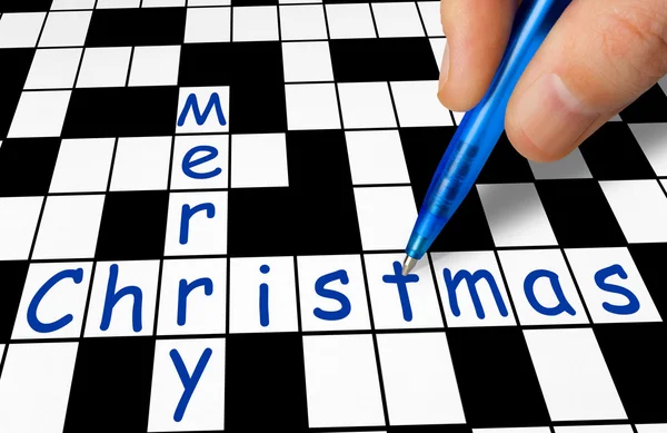 Hand filling in crossword - Merry Christmas — Stock Photo, Image