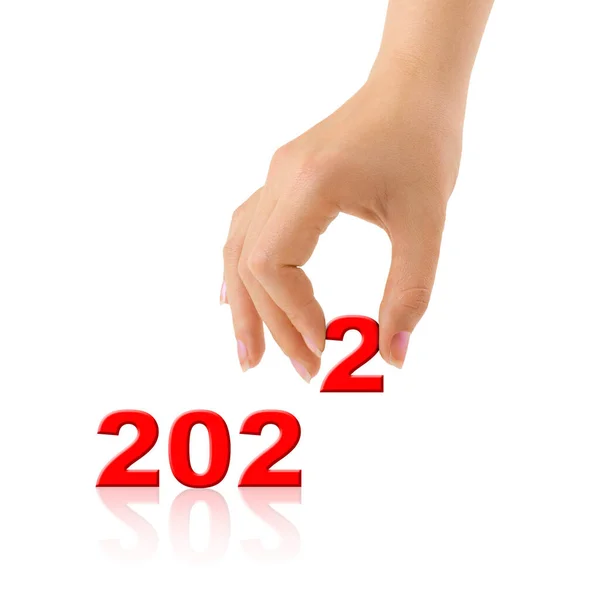 2022年の数字と白地に隔離された手 — ストック写真