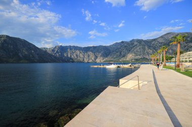 Deniz ve dağlarla güzel bir gezinti manzarası.