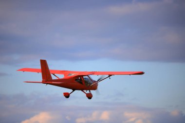 Small private propeller plane flies in the sky