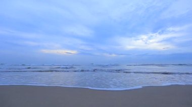 Blue clouds and ocean waves in the evening
