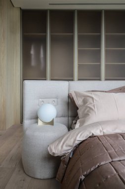 Night light, pillow on the bed in a modern interior