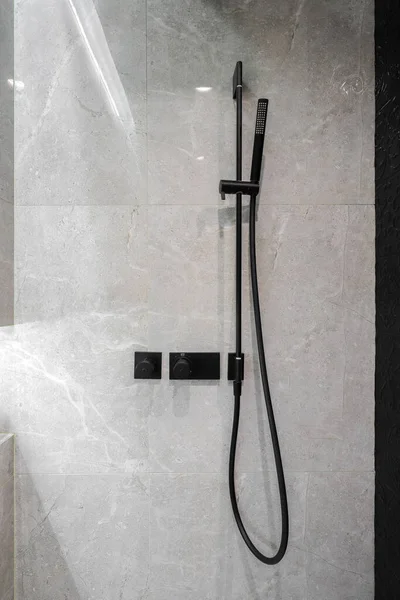 Black shower faucet in the shower room interior