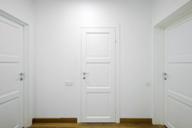 White interior doors in the white corridor 