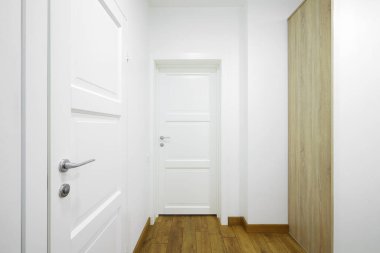 White interior doors in the white corridor 