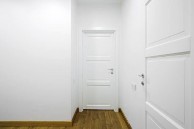 White interior doors in the white corridor 