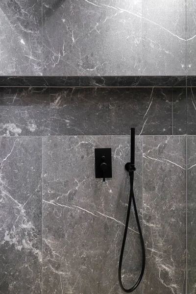 Black shower faucet in the shower room interior