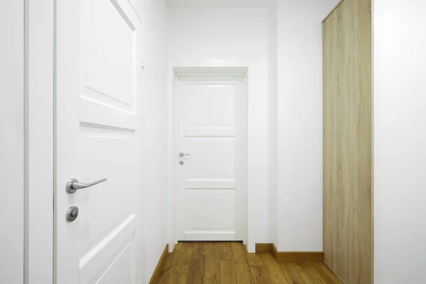 White interior doors in the white corridor