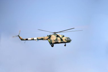 Kyiv, Ukraine - 24 august, 2021: Military helicopter MI-8 flies against the blue sky