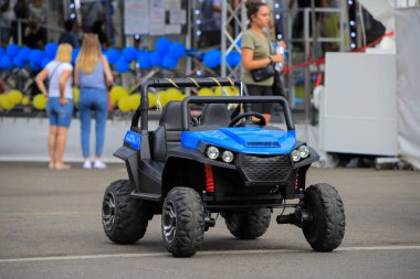 Small blue electric kid car on the street 