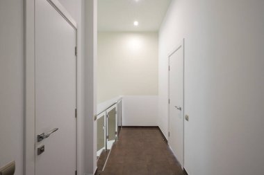 White interior doors in the white corridor