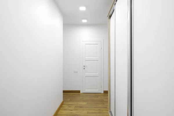 White interior doors in the white corridor