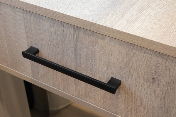 Furniture drawer door handle black color close-up