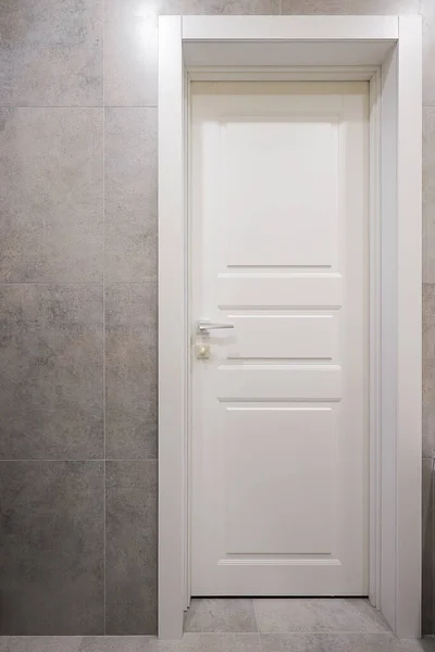 Classic white interior door in the apartment