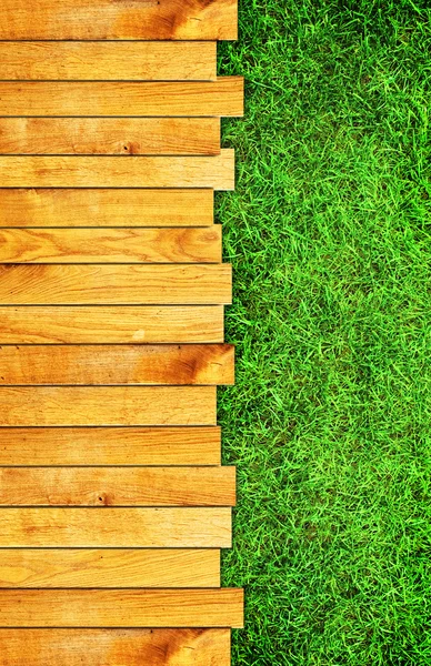 Wooden board on grass — Stock Photo, Image