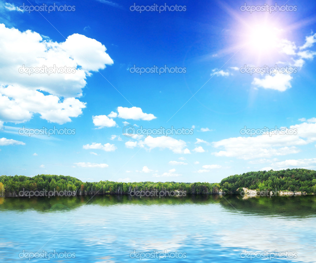 Lake in silent summer day with reflections of clouds