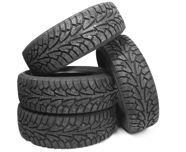 Stack of four new black tyres for winter car — Stock Photo, Image