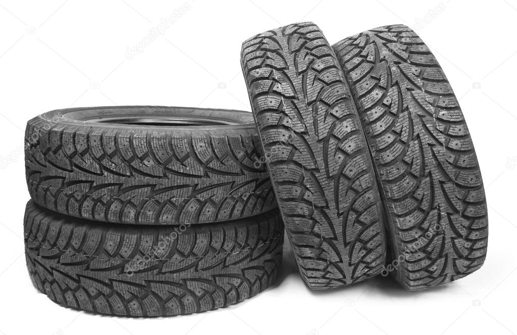 Stack of four new black tyres for winter car